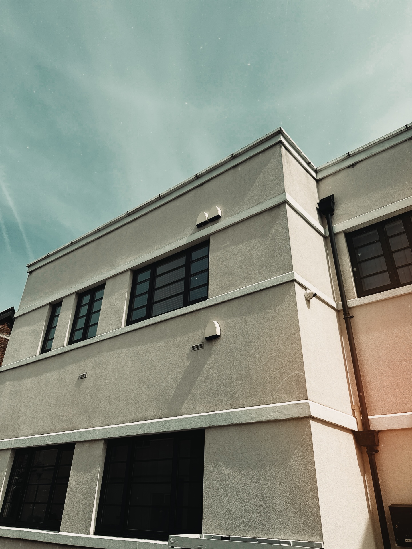 Angular building exterior under a pale blue sky